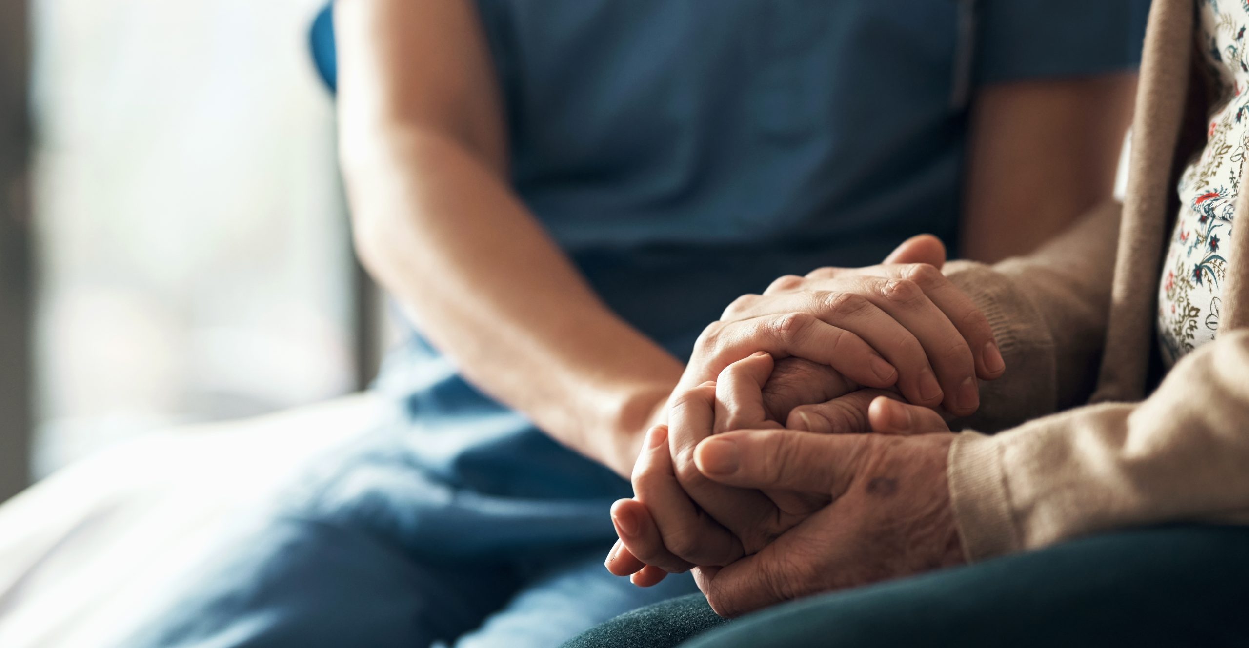 Closeup, hands and nurse with patient, empathy and compassion for grief, loss and sympathy. Zoom, mature lady and caregiver with support, trust and solidarity with bonding, healing together and care