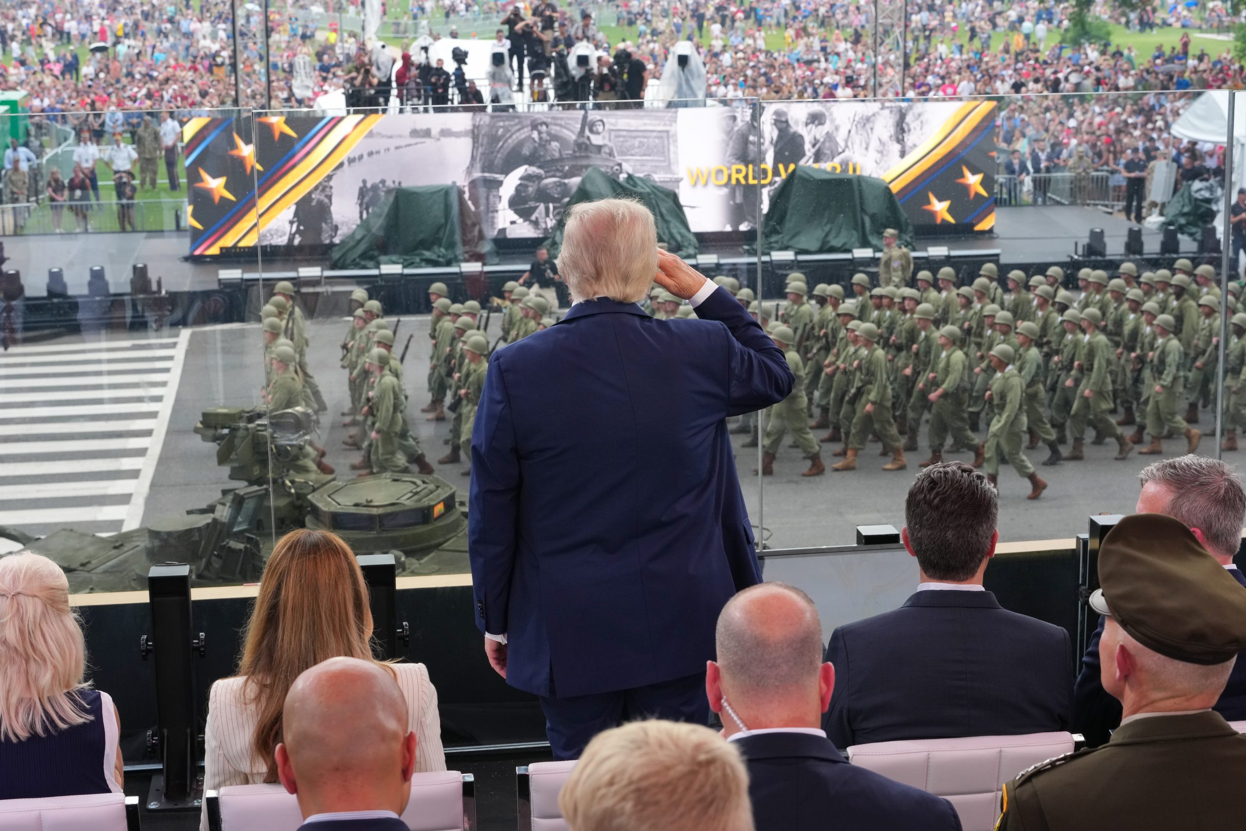 WASHINGTON, DC - JUNE 14: President Donald Trump stands and salutes troops during the celebration of the Army's 250th birthday on the National Mall on June 14, 2025 in Washington, DC. The U.S. Army is marking its 250th anniversary with a military parade along Constitution Avenue that includes roughly 6,600 troops, 150 vehicles, and over 50 aircraft.  The parade, which coincides with President Donald Trump's 79th birthday, is designed to tell the history of the Army. (Photo by Doug Mills - Pool/Getty Images)