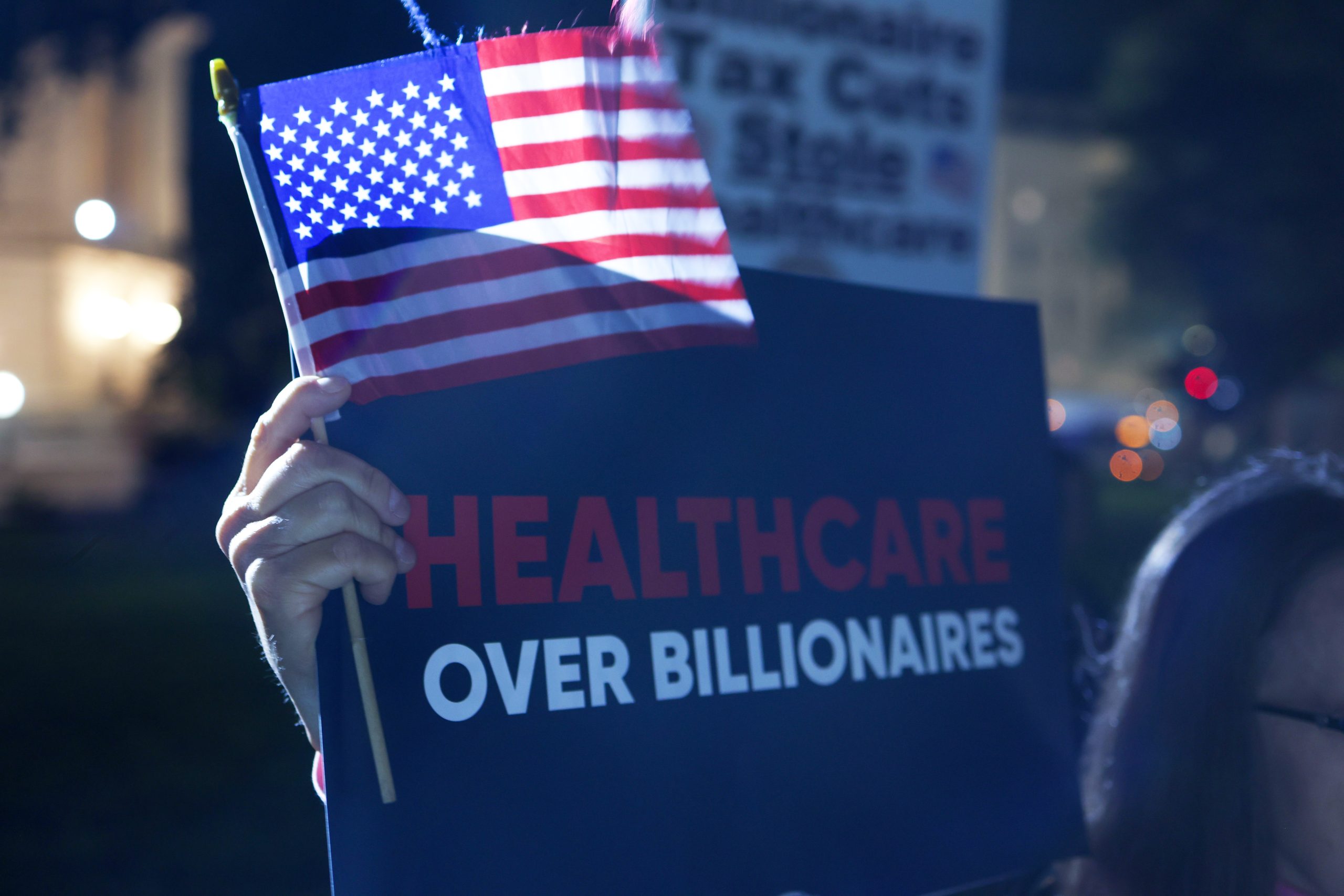 A protester holds up a sign that says 