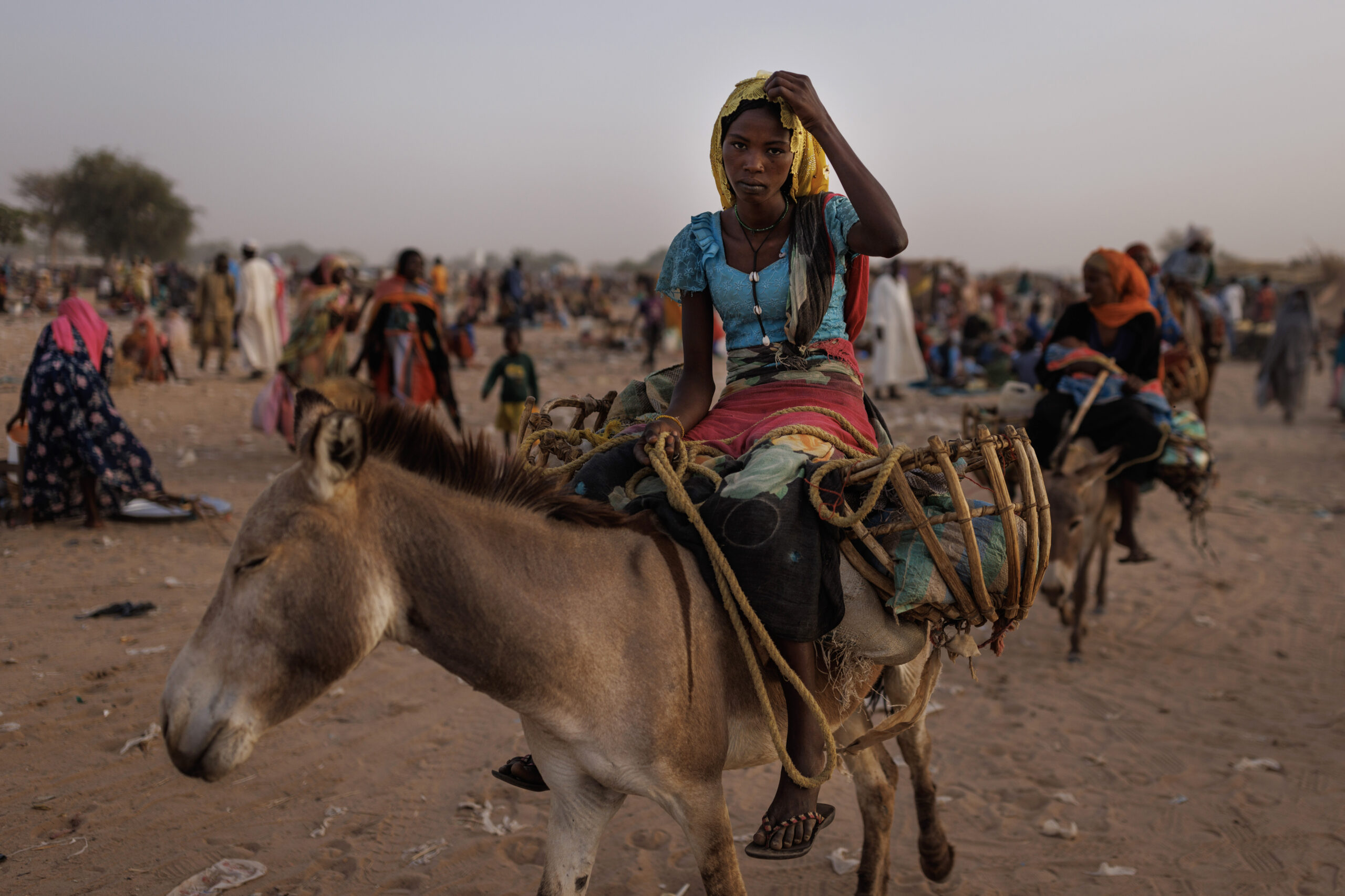ADRE, CHAD - APRIL 24: Newly arrived refugee from Darfur in Sudan, sit on donkey as they head to their shelters on April 24, 2024 in Adre, Chad. Since the beginning of the recent conflict between the paramilitary Rapid Support Forces (RSF) and the the Sudanese Armed Forces, (SAF), which began in March 2023, over 600,000 new refugees have crossed the border from Darfur in Sudan, into Chad. The total number of refugees, including those from previous conflicts, now stands at 1.2 million. Aid agencies, including The World Food Programme, (WFP), Médecins Sans Frontières (MSF) and the United Nations High Commissioner for Refugees, (UNHCR), already struggling with acute supply shortages, have warned that the life-saving programmes in Chad, will ‘grind to a halt in a matter of weeks without urgent funding’. Chad is now home to one of the largest and fastest-growing refugee populations in Africa. (Photo by Dan Kitwood/Getty Images)