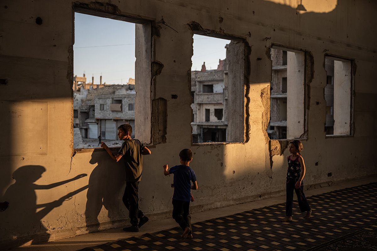 Children play in Ali bin Abi Talib Mosque at sunset on Eid al-Adha in Yarmouk camp, Damascus, on June 6, 2025.